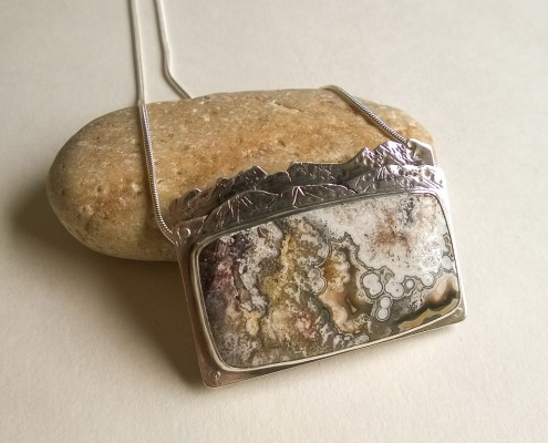 Crazy Lace Agate Riveted Mountain Pendant