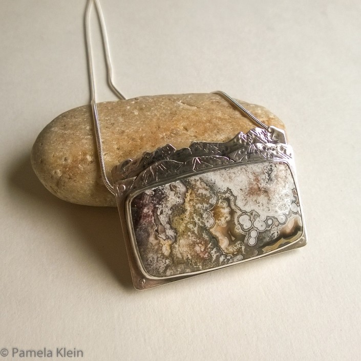Crazy Lace Agate Riveted Mountain Pendant